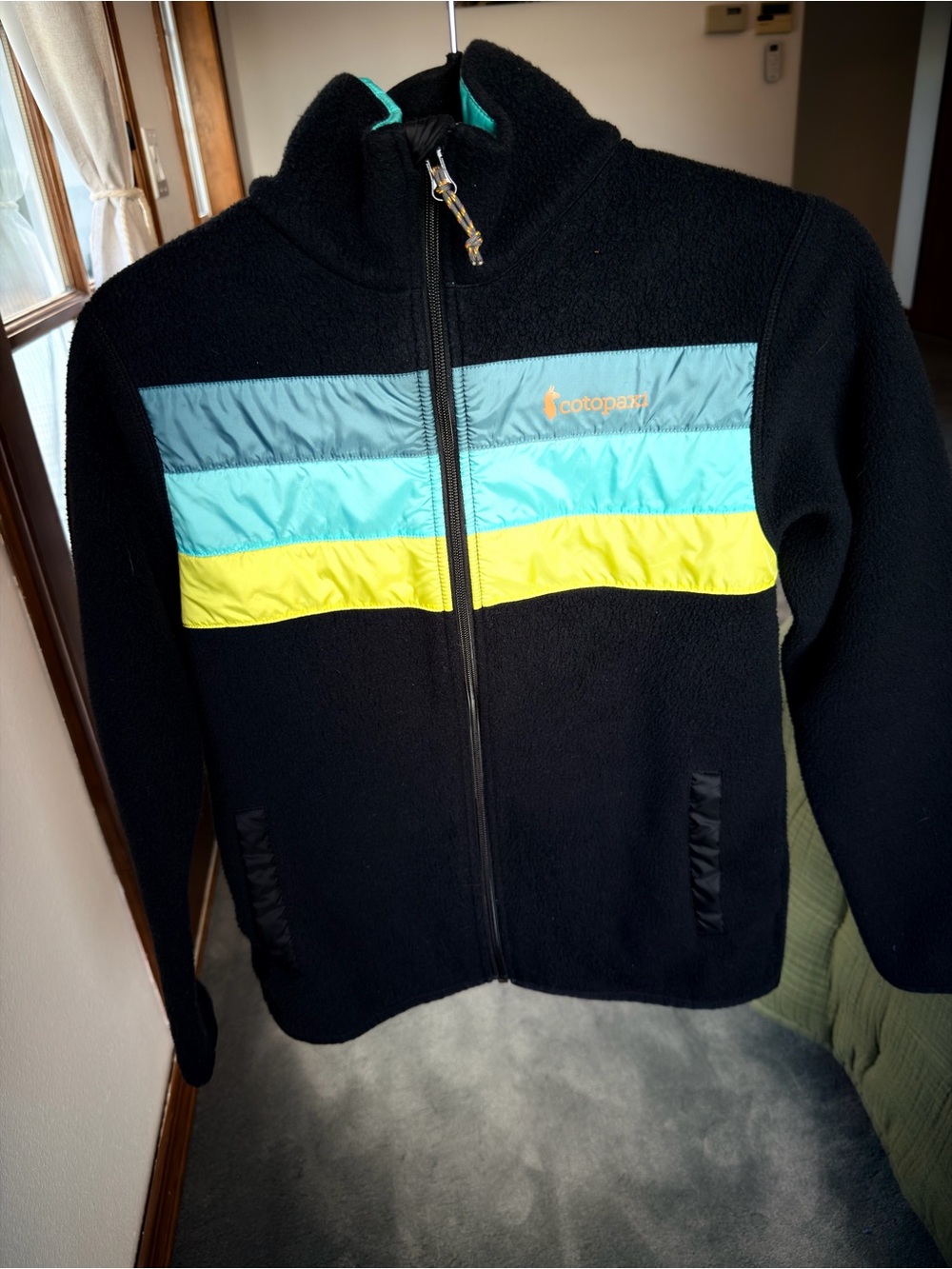 Cotopaxi teca Black Fleece Jacket with Aqua and Yellow Stripes